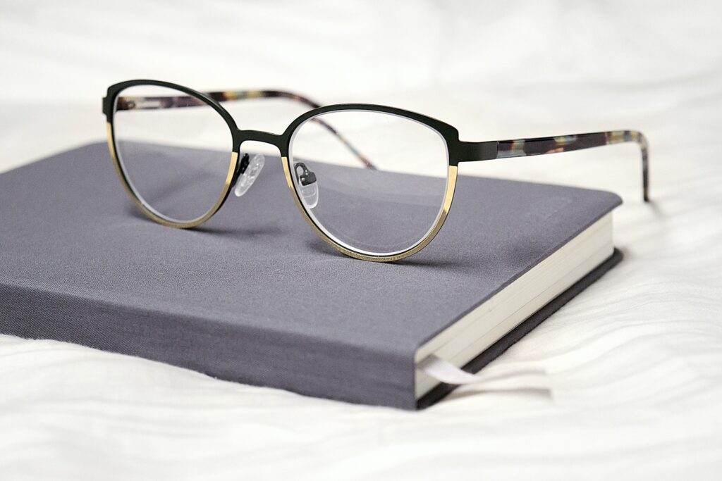 black framed eyeglasses on black book